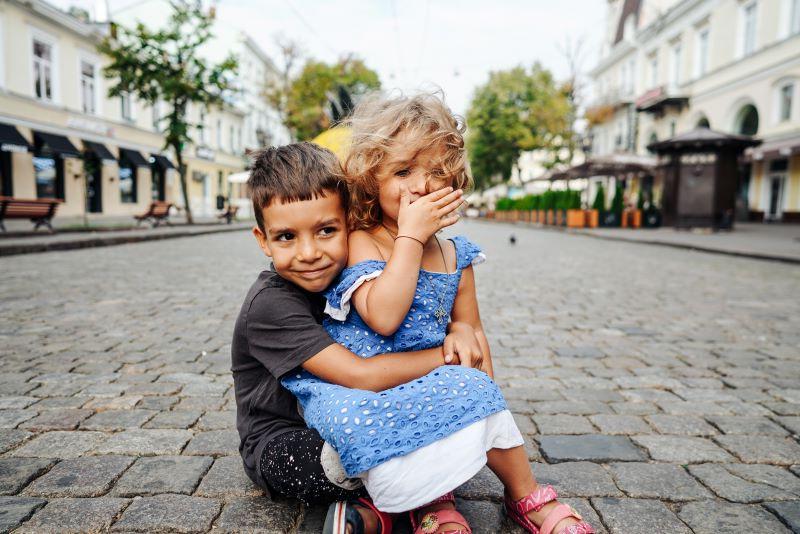 Young children sitting in a street